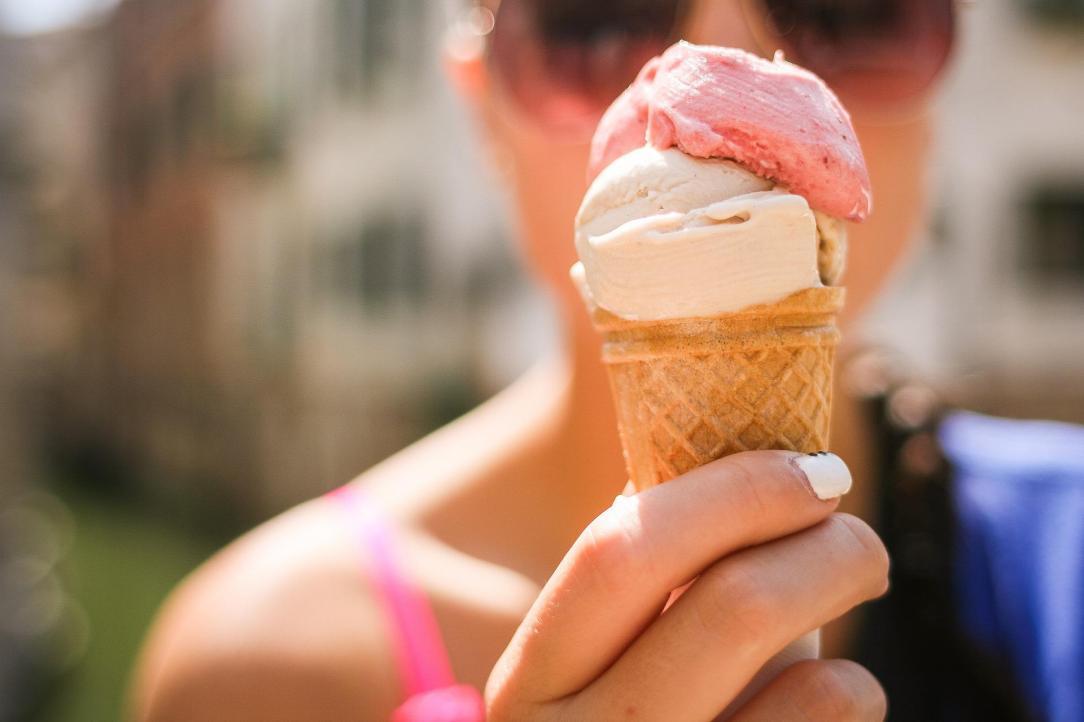 Closeup of woman holding ice cream cone 