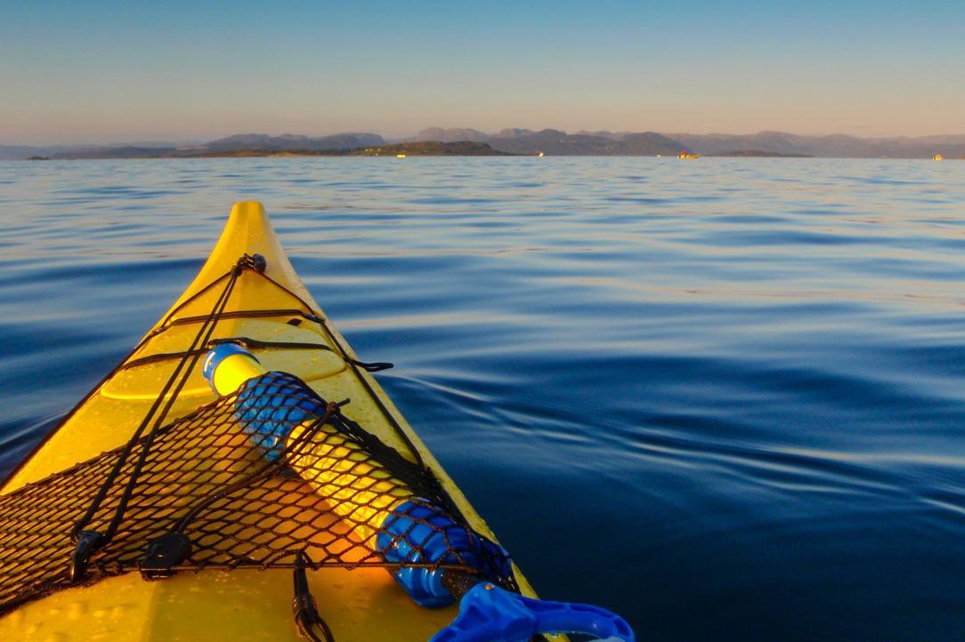 Point of view in a kayak on a calm lake