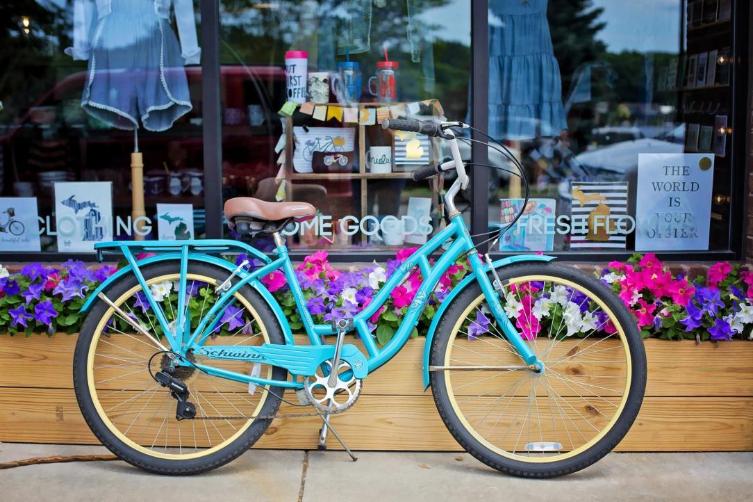 Blue vintage bicycle leaning against a window shop