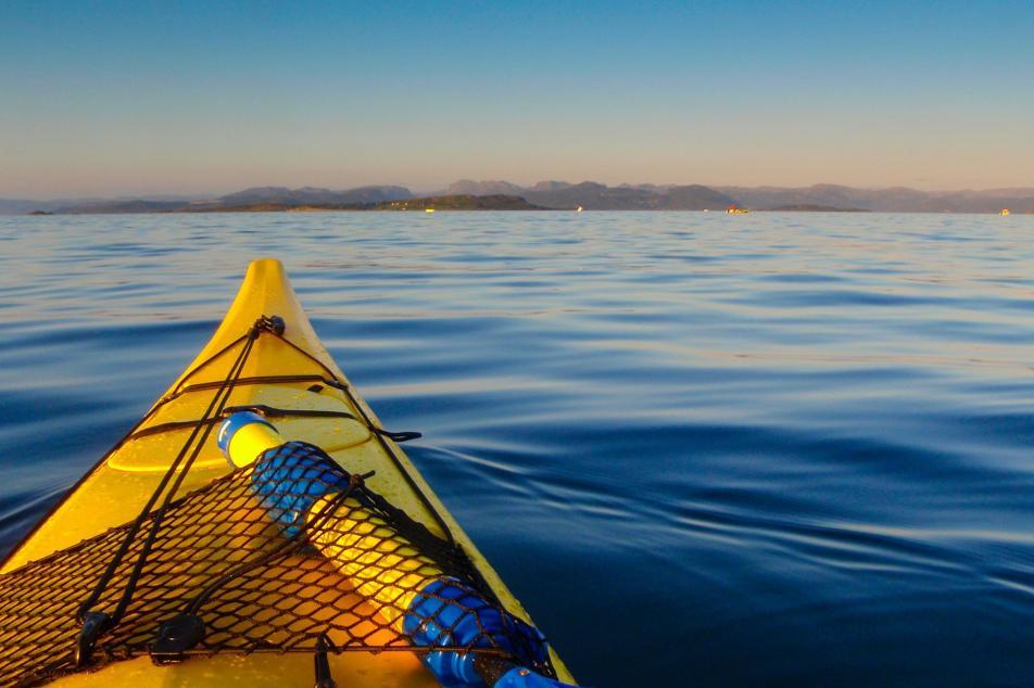 Point of view in a kayak on a calm lake